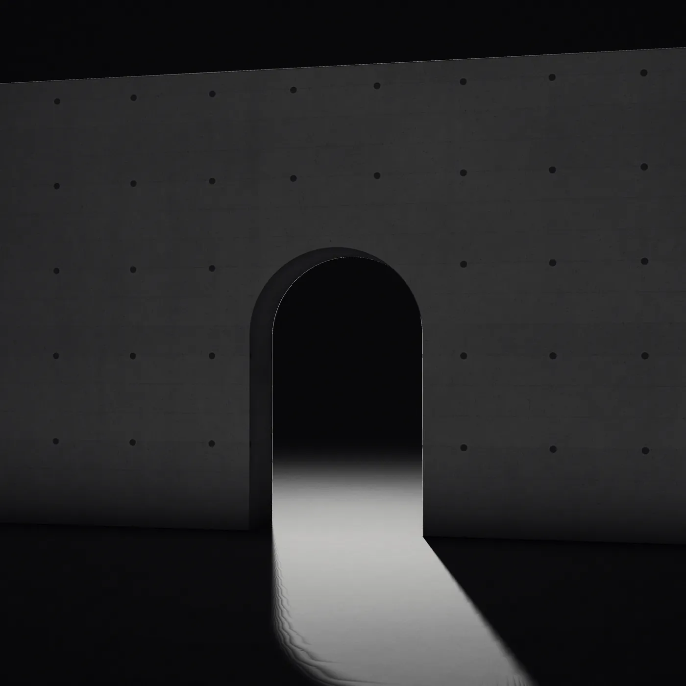 A round-topped opening in a dark concrete wall, under a spotlight