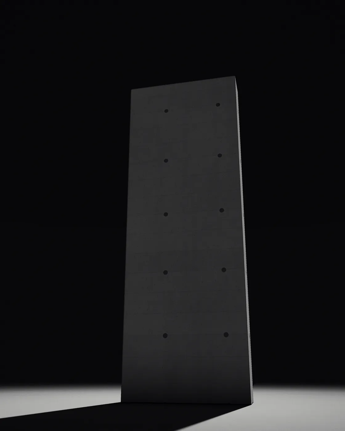 A tall concrete slab standing alone in the dark